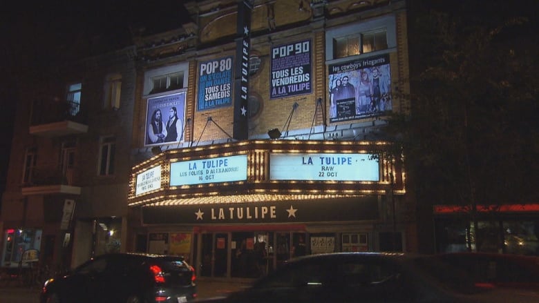 The music venue La Tulipe is seen from outside at night with its marquee illuminated