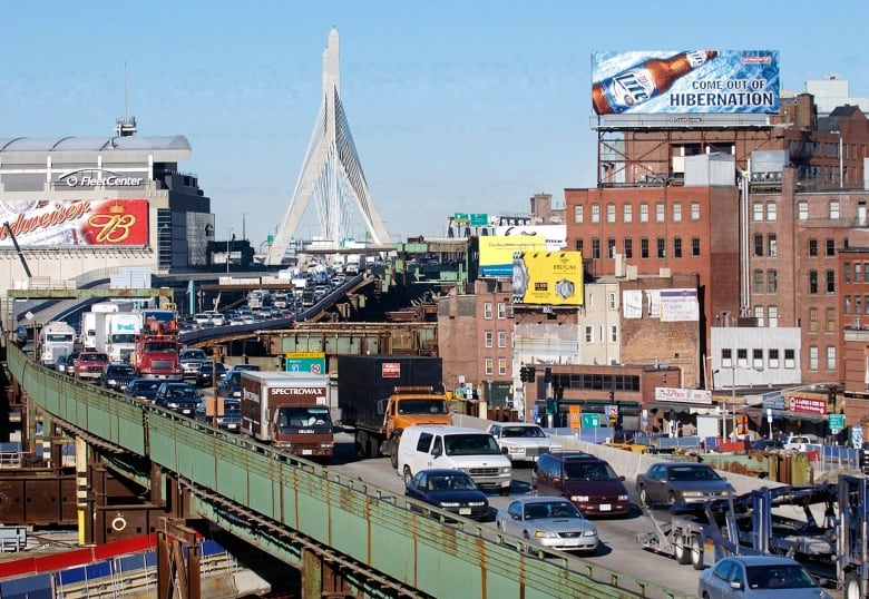 A congested highway weaves through the centre of a city.