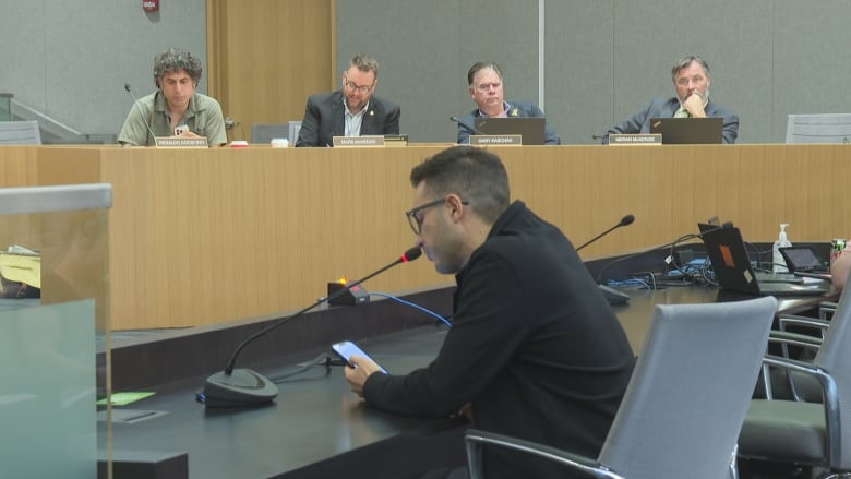 A man speaks at a municipal meeting.