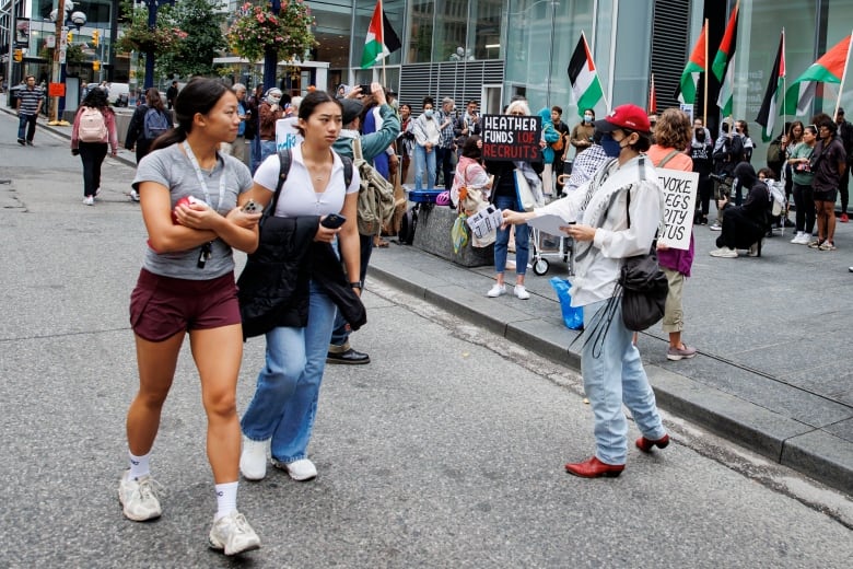 Activists hold a rally outside a Toronto Indigo bookstore as part of a Canada-wide boycott campaign. 