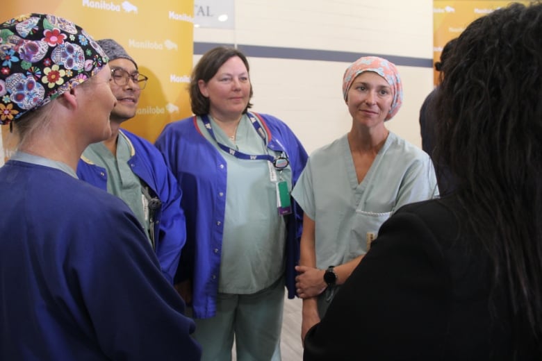 A group of nurses stand side by side 