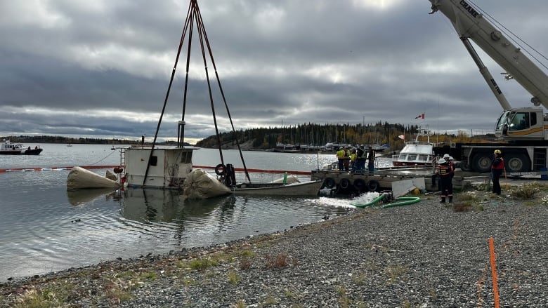 Fishing boat attached to crane