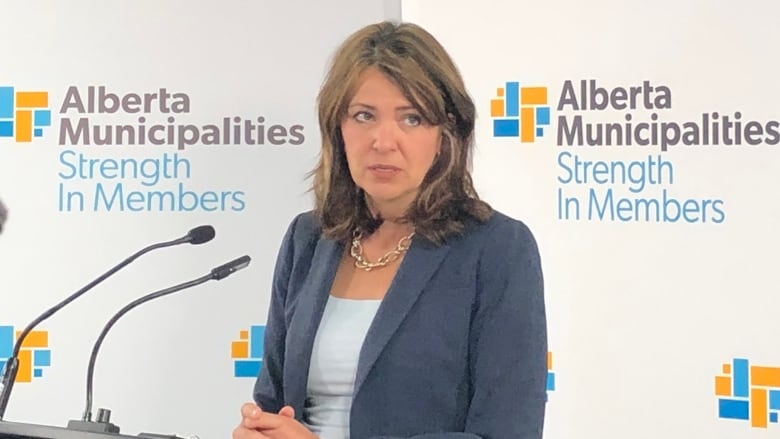 A woman speaks at a podium. 