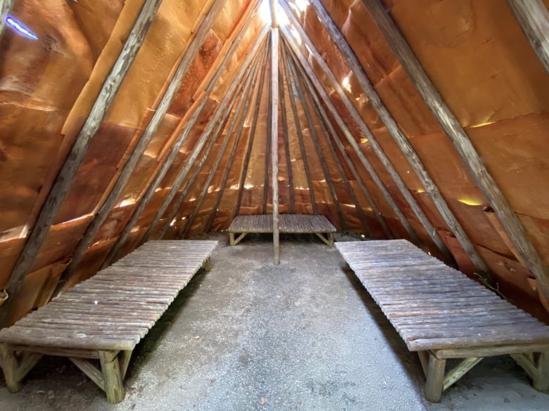 The inside of a longhouse with three benches