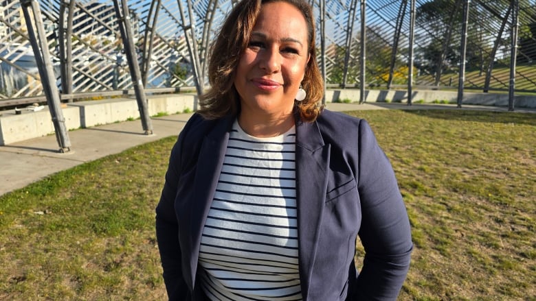 A woman smiles and poses for a photo.