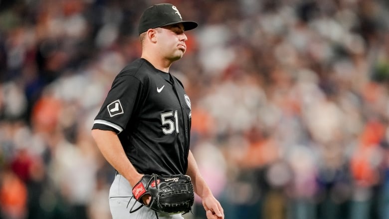 A male baseball player looks dejected.