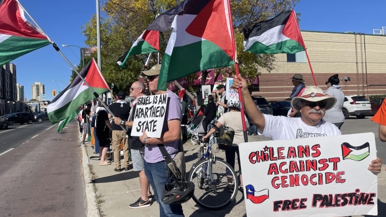 People  waving flags at a rally. 