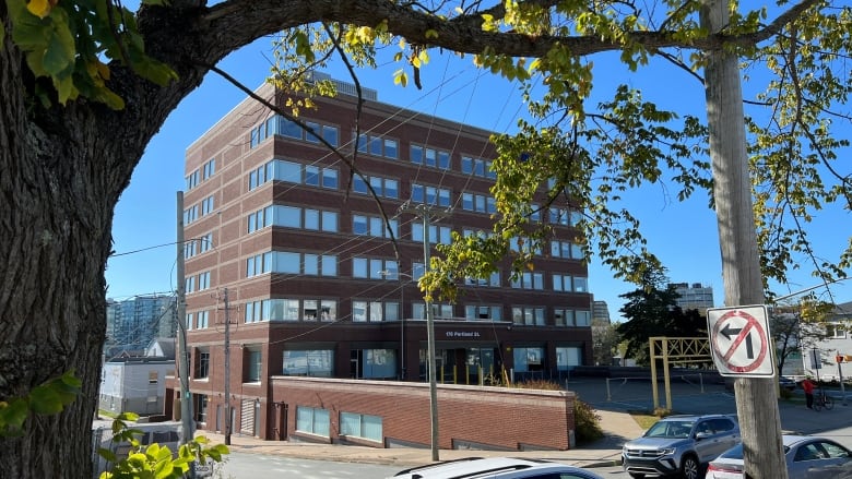 A multi-story brick building is shown. 