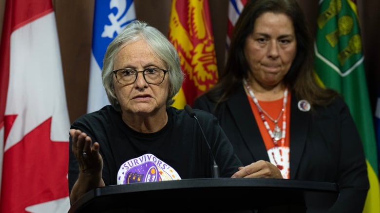 The Survivors Secretariat Executive Lead Laura Arndt, right, looks on as Mohawk Institute survivor and Secretariat board member Roberta Hill speaks during a news conference on Parliament Hill, in Ottawa, Monday, Sept. 30, 2024.