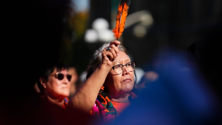 A survivor of the residential school system stands amongst others to be acknowledged during a ceremony on Parliament Hill to commemorate Truth and Reconciliation Day, in Ottawa, Monday, Sept. 30, 2024.