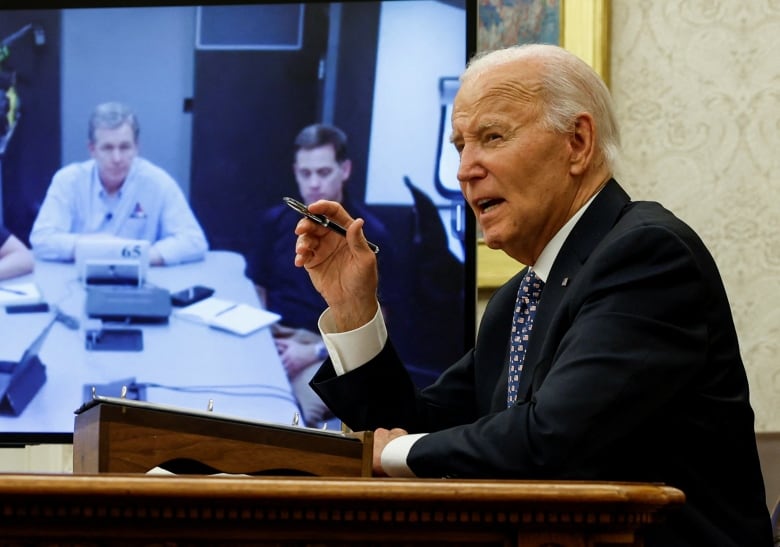 Biden speaking to men on a screen