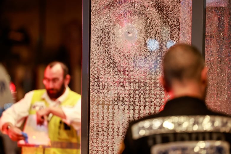 Shattered glass is seen in the aftermath of a shooting in Tel Aviv's Jaffa area on Tuesday, Oct. 1, 2024.