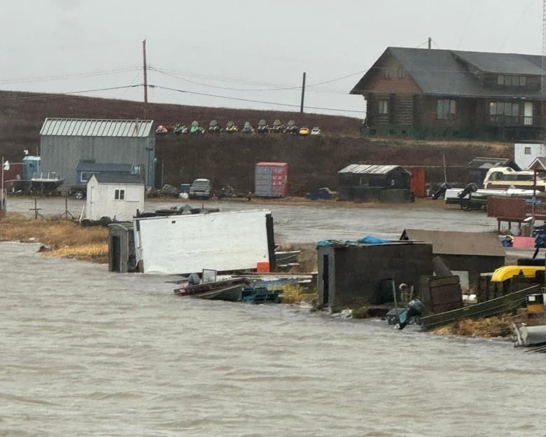 High water can be seen on the coastline, with boats and other small structures.