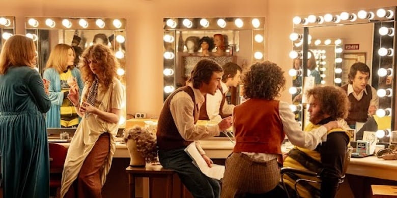 In the make-up room Lorne Michaels tries to convince John Belushi to sign his contract before the show goes to air.   From left, Jane Curtin (Kim Matula), Laraine Newman (Emily Fairn), Lorne Michaels (Gabriel LaBelle), Rosie Shuster (Rachel Sennott), and John Belushi (Matt Wood).