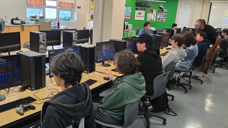 High school students play video games in a computer lab.