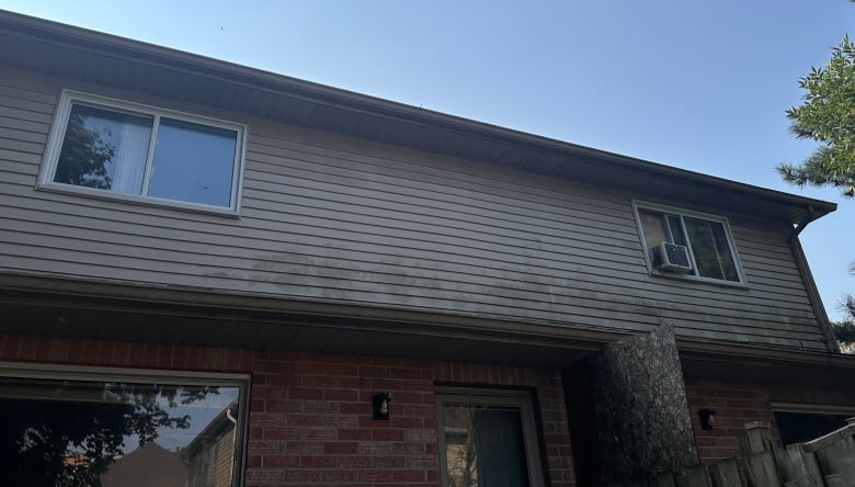 The window with the air conditioning unit belongs to the man charged with sexual assault. The other window leads to the bedroom of the 13-year-old girl, through which he is believed to have entered. 