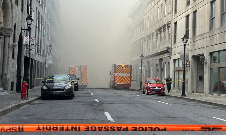 Street with smoke and fire trucks.