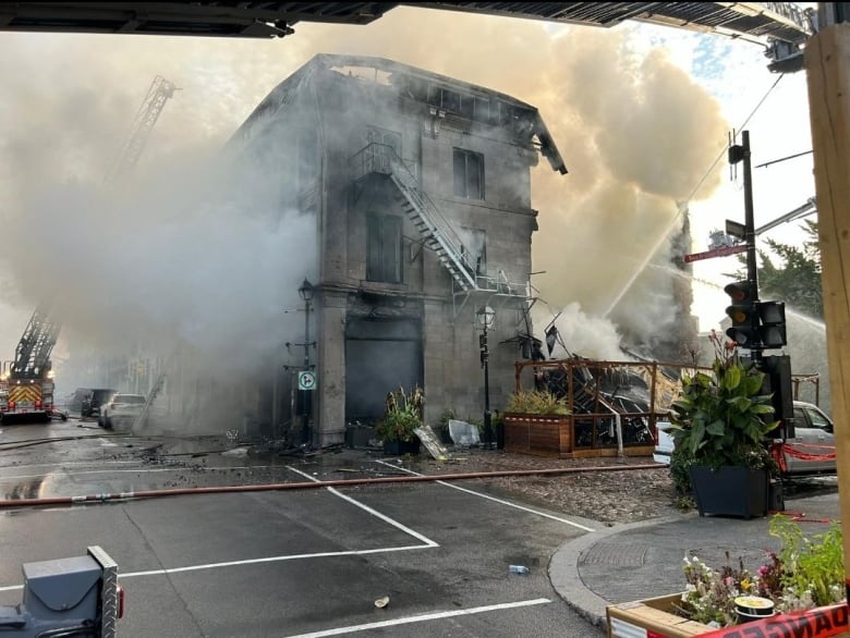 A burned out building with smoke. 