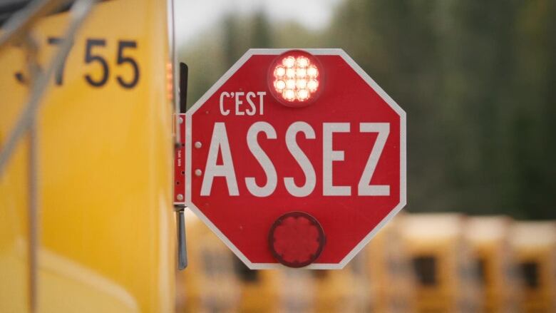 A stop sign on a school bus says in French 