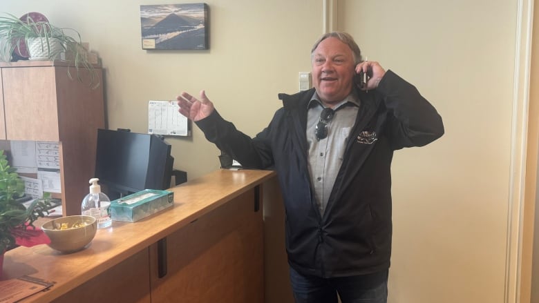 A man on a phone in an office.