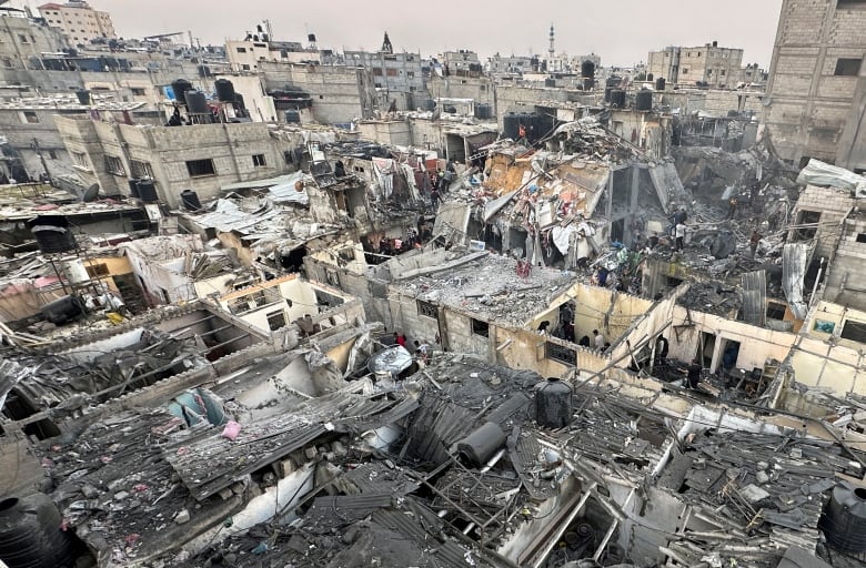 People search through the rubble of damaged buildings following an Israeli air strike on Palestinian houses, amid the ongoing conflict between Israel and the Palestinian Islamist group Hamas, in Rafah in the southern Gaza Strip December 12, 2023.