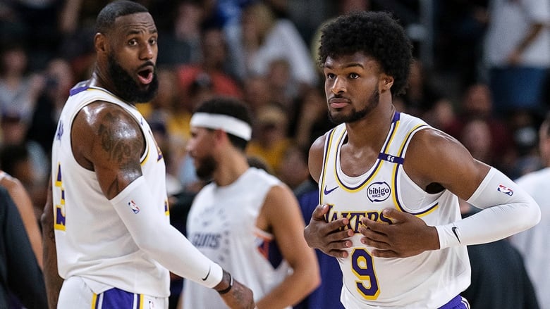 Los Angeles Lakers guard Bronny James steps on the court with forward LeBron James, his dad, during the first half of an Oct. 6, 2024 NBA pre-season game in Palm Desert, Calif. 