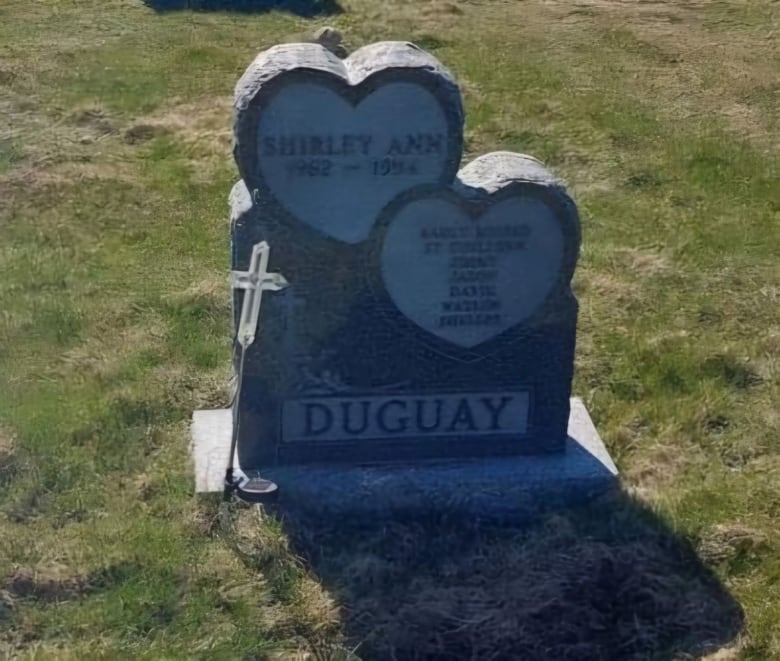 A headstone in a graveyard.