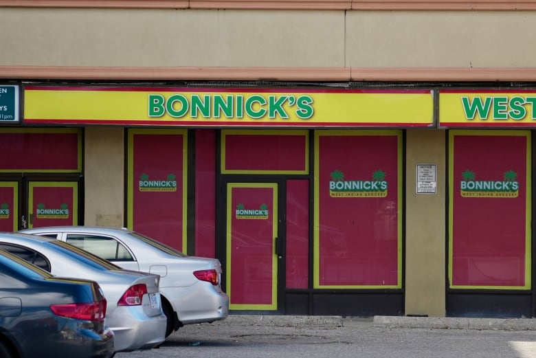 A grocery store with paper covering the windows and doors. 