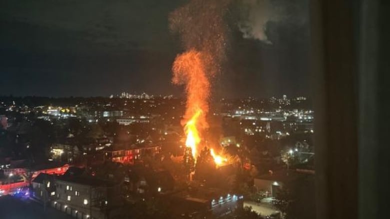 A far away shot of a large fire at night. 