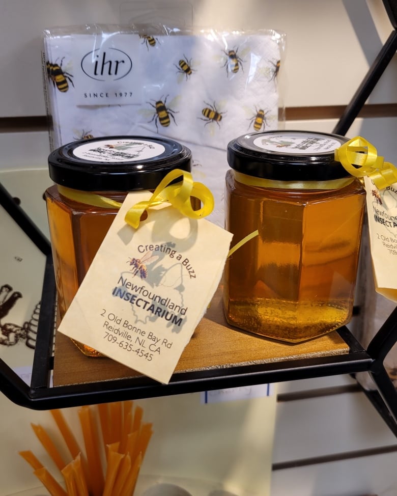 A close up of two jars filled with honey.