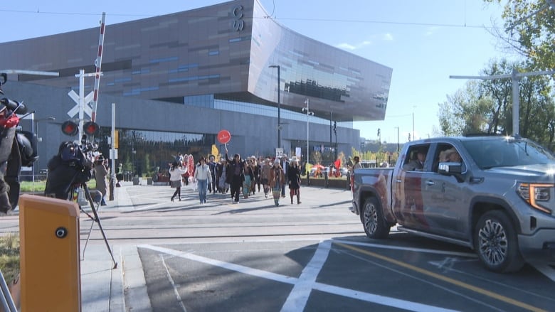 a truck drives through an intersection in a city on a sunny day