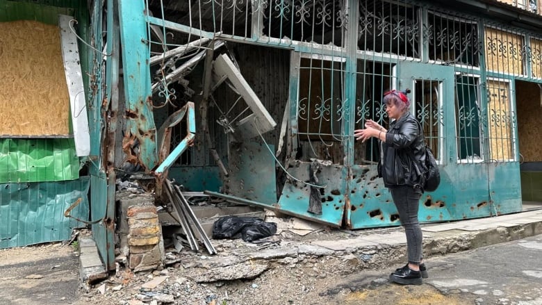 Olga Chernyshova is seen outside her family's grocery shop in the city of Kherson in southern Ukraine.