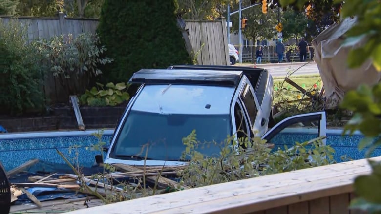 A pickup truck is in a pool.