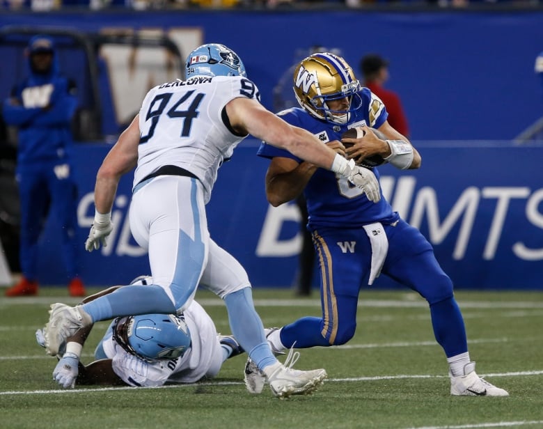 A player in white prepares to tackle a ball-carrier in blue.