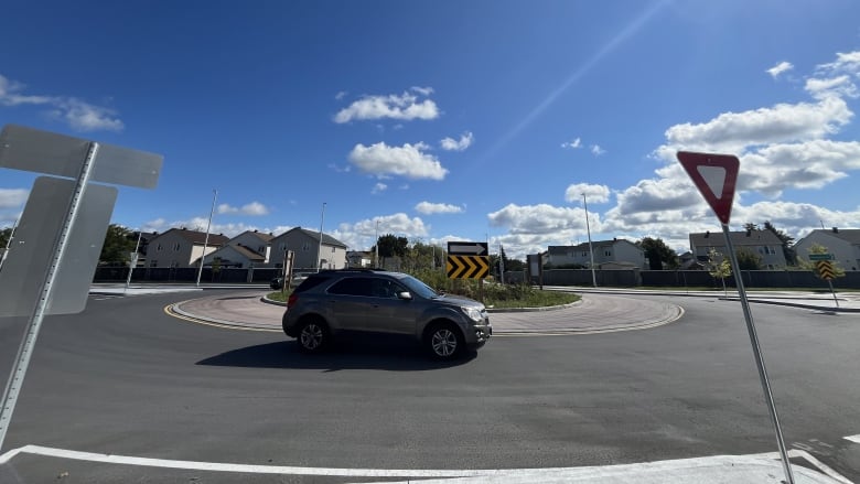 A car drives around a roundabout.