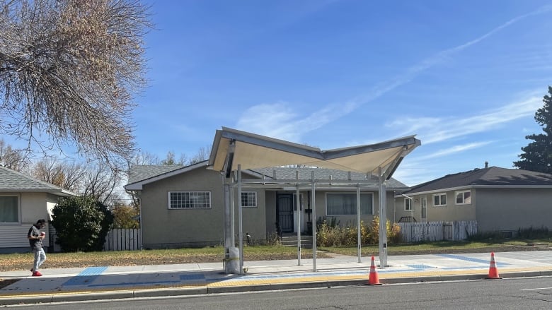 A bus shelter in front of a home