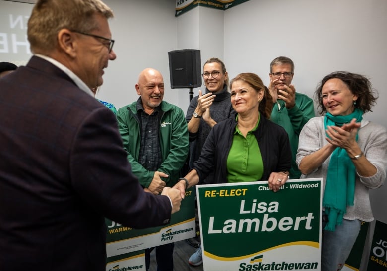 Saskatchewan Party Leader Scott Moe, left, shakes hands with Lisa Lambert, candidate for Saskatoon Churchill-Wildwood, at an event where he released the Saskatchewan Partys election platform in Saskatoon, Sask. on Saturday, October 12.