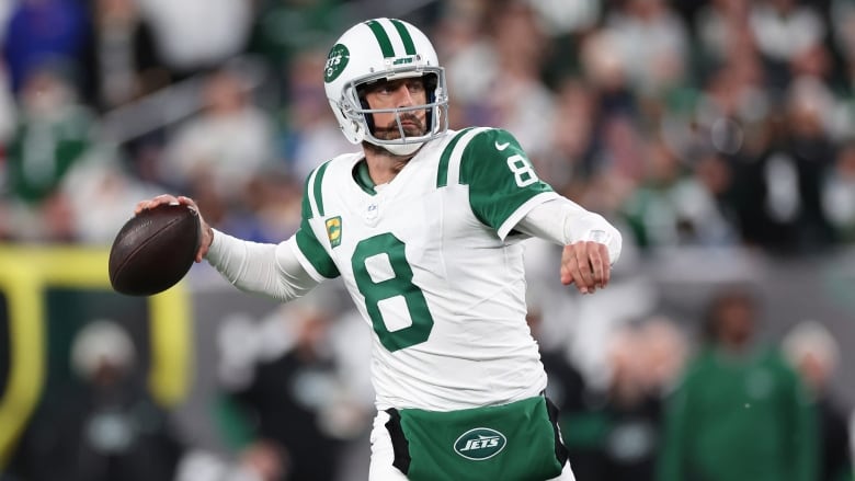 A male football player is seen throwing a pass during a game.