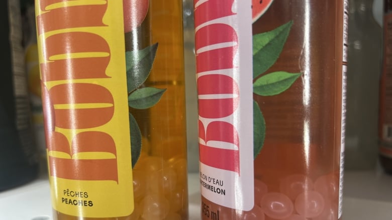 Two bottles of a bubble tea beverage are shown on a supermarket shelf.