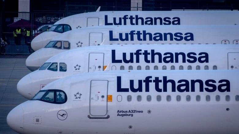 Four grounded planes marked with the word Lufthansa are shown.