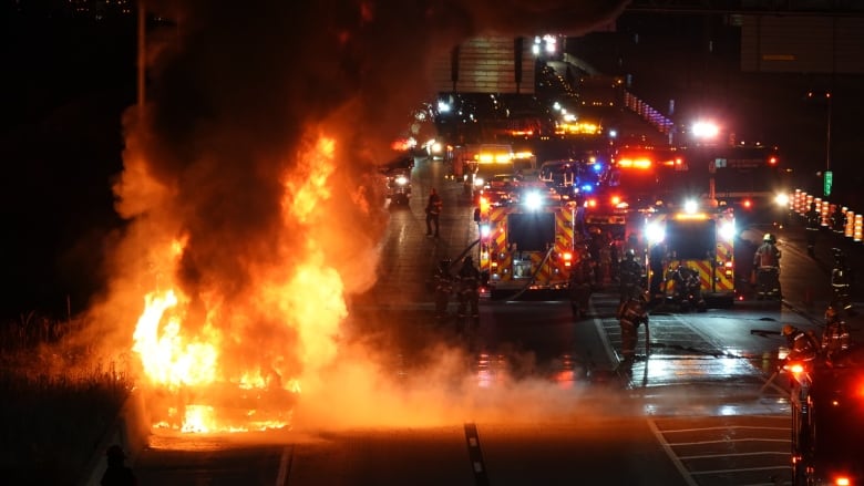 Firefighters on the scene of a highway. 