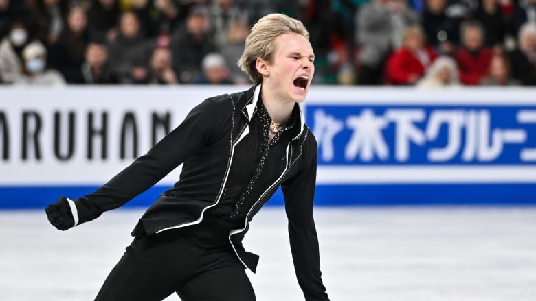 A men's figure skater celebrates.