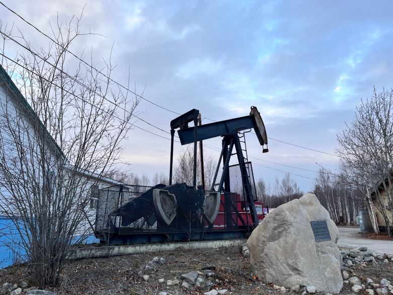 a oil derrick against a clouded sky