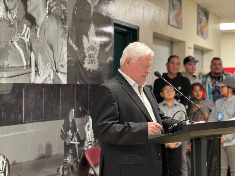 A man stands at a podium