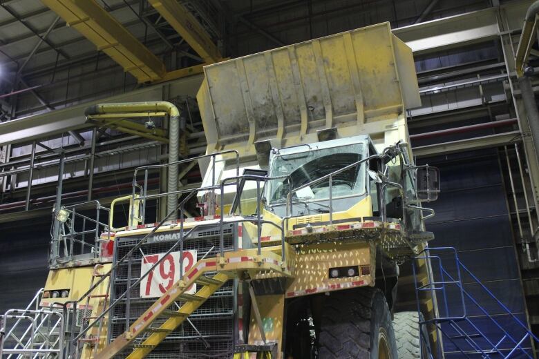 A big truck inside an industrial building.