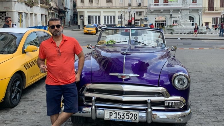 Man standing next to a car