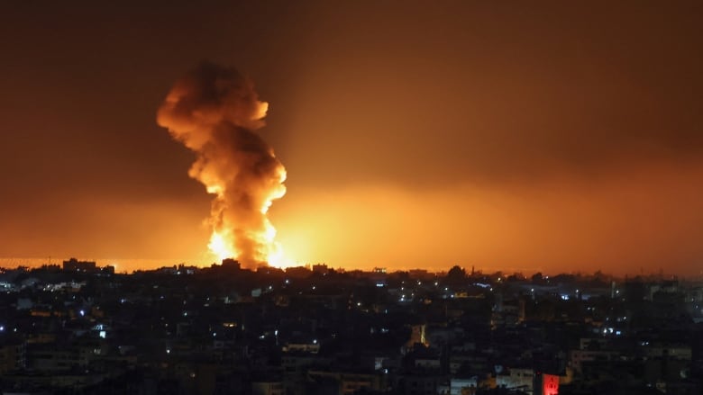 An explosion seen from a distance in a night sky.