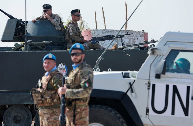 United Nations peacekeepers (UNIFIL) stand guard near Lebanese army soldiers sitting on their armored vehicle in Naqoura, near the Lebanese-Israeli border, southern Lebanon, October 27, 2022