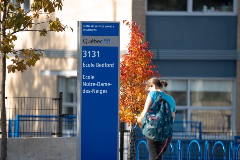 A person in front of a school