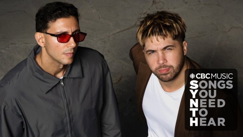 Majid (a Middle Eastern man) and Jordan (a white man) gaze up at the camera. Majid wears a grey zip-up jacket and red sunglasses and Jordan wears a brown suit with a white shirt. The CBC Music logo and the text: songs you need to hear appear in the bottom right corner. 